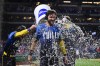 Philadelphia Phillies' Trea Turner, center, is doused by Brandon Marsh, left, and Bryson Stott after hitting a walk-off RBI-single off Washington Nationals' Kyle Finnegan during the ninth inning of a baseball game, Friday, Aug. 16, 2024, in Philadelphia. (AP Photo/Derik Hamilton)