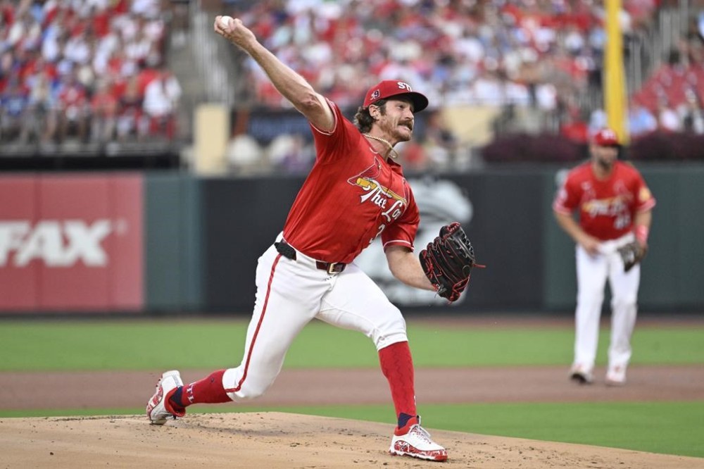 St. Louis Cardinals starting pitcher Miles Mikolas foreground, throws against the Los Angeles Dodgers during the first inning of a baseball game Friday, Aug. 16, 2024, in St. Louis. (AP Photo/Jeff Le)
