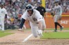 Detroit Tigers' Spencer Torkelson leaps towards home plate on a passed pitch during the sixth inning of a baseball game av], Saturday, Aug. 17, 2024, in Detroit. (AP Photo/Carlos Osorio)