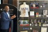 Former Texas Rangers third baseman Adrian Beltre looks at some of the memorabilia from his Hall of Fame playing days in a display that the team unveiled Friday, Aug. 16, 2024, in Arlington, Texas. (AP Photo/Stephen Hawkins)