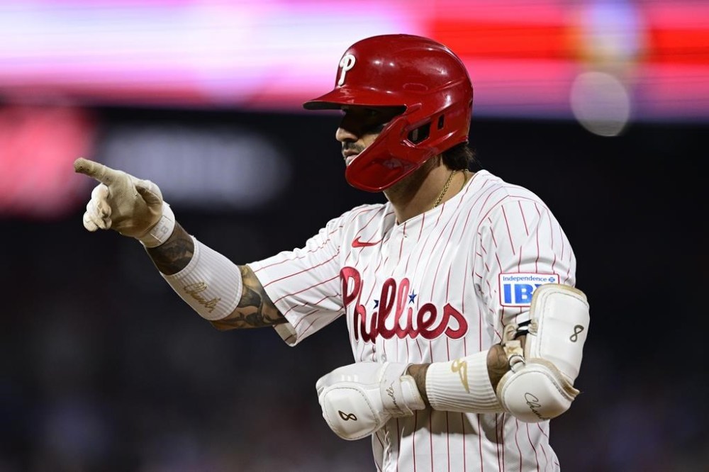 Philadelphia Phillies' Nick Castellanos gestures after hitting a single off Washington Nationals' MacKenzie Gore during the sixth inning of a baseball game, Saturday, Aug. 17, 2024, in Philadelphia. (AP Photo/Derik Hamilton)