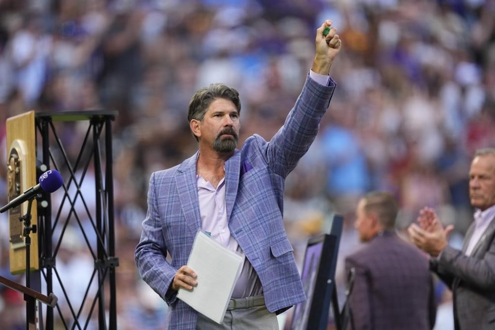 Retired Colorado Rockies first baseman and Major League Baseball Hall of Famer Todd Helton waves to the crowd during a ceremony to mark his induction into the Hall last month before a baseball game, Saturday, Aug. 17, 2024, in Denver. (AP Photo/David Zalubowski)