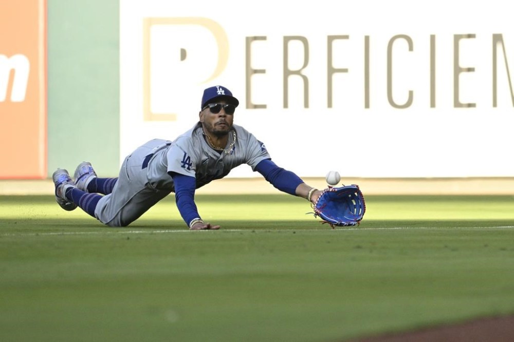 Los Angeles Dodgers right fielder Mookie Betts catches a fly ball from St. Louis Cardinals' Masyn Winn during the first inning of a baseball game Saturday, Aug. 17, 2024, in St. Louis. (AP Photo/Jeff Le)