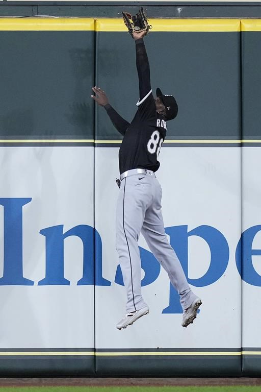 Chicago White Sox center fielder Luis Robert Jr. catches a fly ball hit by Houston Astros' Victor Caratini during the seventh inning of a baseball game Saturday, Aug. 17, 2024, in Houston. (AP Photo/Kevin M. Cox)
