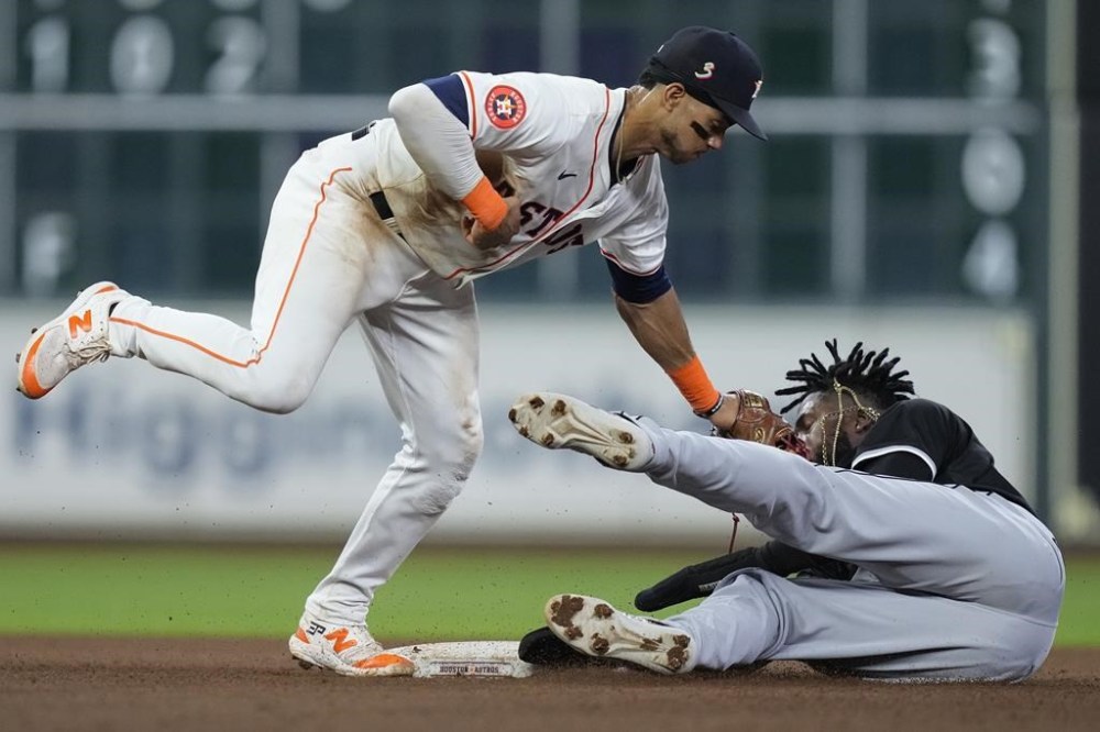 Houston Astros shortstop Jeremy Peña, left, catches Chicago White Sox's Luis Robert Jr. attempting to steal second base during the sixth inning of a baseball game Saturday, Aug. 17, 2024, in Houston. (AP Photo/Kevin M. Cox)