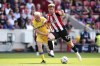 Crystal Palace's Will Hughes, left, and Brentford's Nathan Collins battle for the ball during the English Premier League soccer match between Crystal Palace and Brentford at the Gtech Community Stadium, Brentford, England, Sunday Aug. 18, 2024. (John Walton/PA via AP)