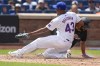 Miami Marlins' Derek Hill, right, scores past New York Mets pitcher Huascar Brazobán (43) after a wild pitch during the seventh inning of a baseball game at Citi Field, Sunday, Aug. 18, 2024, in New York. (AP Photo/Seth Wenig)