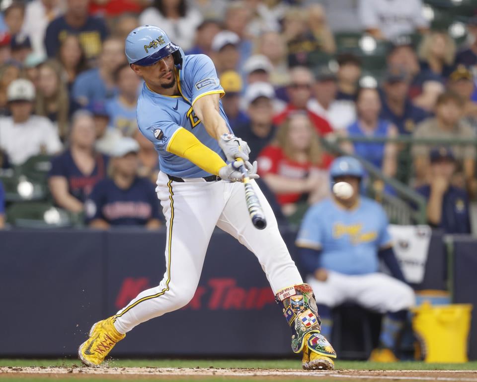 Milwaukee Brewers' Willy Adames hits a run-scoring single during the first inning of a baseball game against the Cleveland Guardians Sunday, Aug. 18, 2024, in Milwaukee. (AP Photo/Jeffrey Phelps)