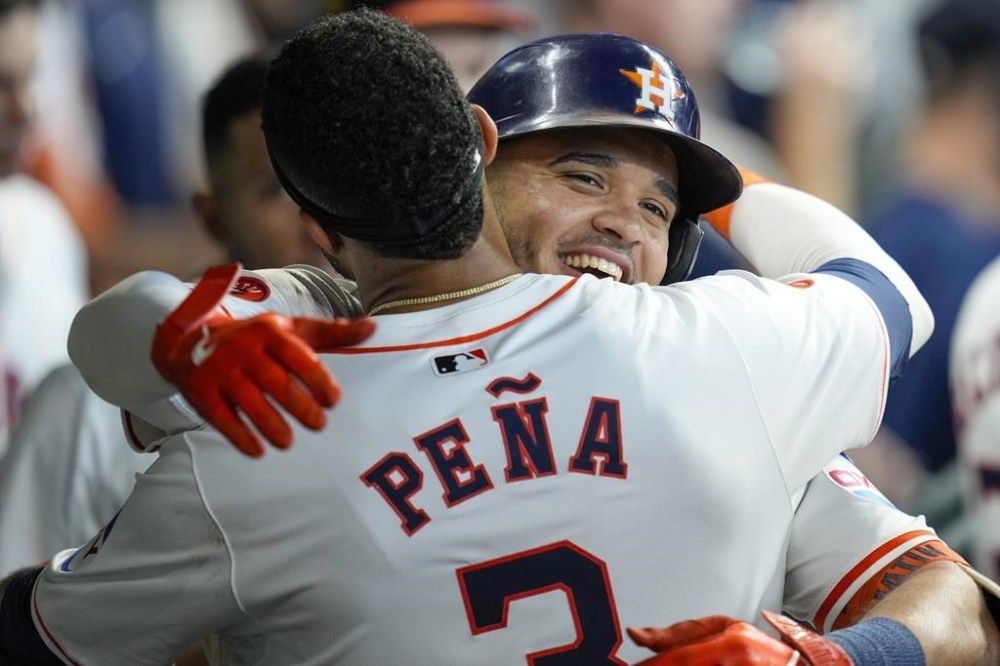 Houston Astros' Yainer Diaz, right, hugs Jeremy Pena after hitting a solo home run against the Chicago White Sox during the sixth inning of a baseball game Sunday, Aug. 18, 2024, in Houston. (AP Photo/Eric Christian Smith)