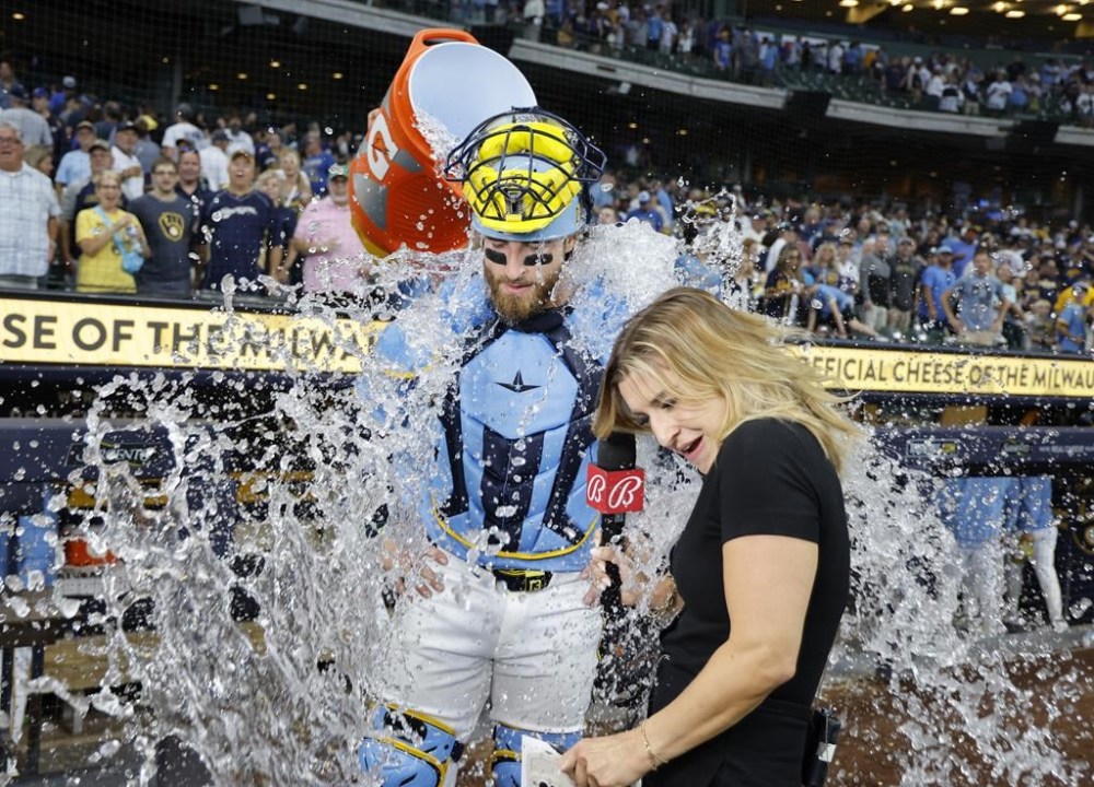 Milwaukee Brewers' Eric Haase, left, is doused after his team defeated the Cleveland Guardians in a baseball game Sunday, Aug. 18, 2024, in Milwaukee. (AP Photo/Jeffrey Phelps)