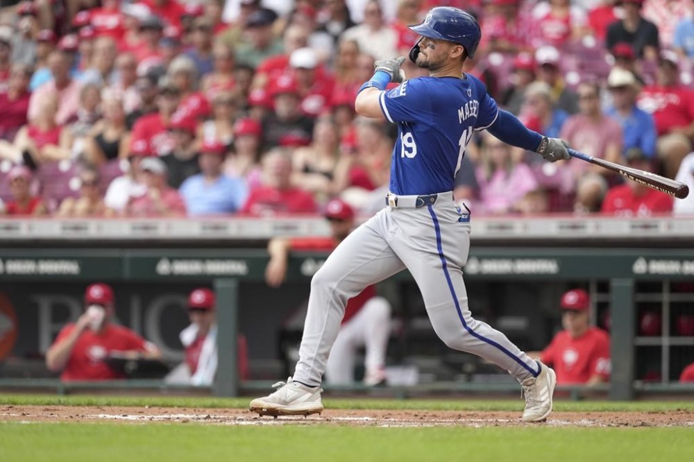 Kansas City Royals' Hunter Renfroe follows through on a single during the second inning of a baseball game against the Cincinnati Reds, Sunday, Aug. 18, 2024, in Cincinnati. (AP Photo/Kareem Elgazzar)