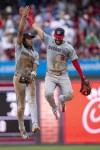 Washington Nationals shortstop C.J. Abrams, left, celebrates with second baseman Luis Garcia, right, after they won a baseball game against the Philadelphia Phillies, Sunday, Aug. 18, 2024, in Philadelphia. (AP Photo/Chris Szagola)