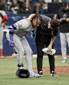 Arizona Diamondbacks Ketel Marte, left, is helped after being injured while batting during the 10th inning of a baseball game against the Tampa Bay Rays, Sunday, Aug. 18, 2024, in St. Petersburg, Fla. (AP Photo/Jason Behnken)