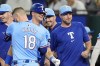 Texas Rangers' Carson Kelly (18), Josh Jung, center, and Max Scherzer, right, celebrate in the 10th inning of a baseball game after the team's 6-5 win against the Minnesota Twins, Sunday, Aug. 18, 2024, in Arlington, Texas. (AP Photo/Tony Gutierrez)
