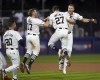 Detroit Tigers' Parker Meadows, right, celebrates with Trey Sweeney (27), Jace Jung (17) and Spencer Torkelson (20) after his game winning hit against the New York Yankees during the tenth inning of a baseball game at the MLB Little League Classic t in Williamsport, Pa., Sunday, Aug. 18, 2024. (AP Photo/Tom E. Puskar)