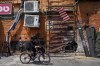A boy rides a bicycle past the damage after a bomb explosion in Tel Aviv, Israel, Monday, Aug. 19, 2024. (AP Photo/Ohad Zwigenberg)