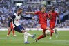 Tottenham Hotspur's James Maddison, left, and Bayern Munich's Josip Stanisic challenge for the ball during the friendly soccer match between Tottenham Hotspur and Bayern Munich, at the Tottenham Hotspur Stadium, London, Saturday, August 10, 2024. (Bradley Collyer/PA via AP)