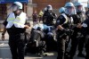 Police take a protester into custody after a fence surrounding United Center was knock down at the Democratic National Convention after a march Monday, Aug. 19, 2024, in Chicago. (AP Photo/Frank Franklin II)