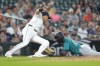 Seattle Mariners' Victor Robles (10) slides safely into third base as Detroit Tigers third base Gio Urshela (13) is late with the tag in the eighth inning of a baseball game, Wednesday, Aug. 14, 2024, in Detroit. (AP Photo/Paul Sancya)