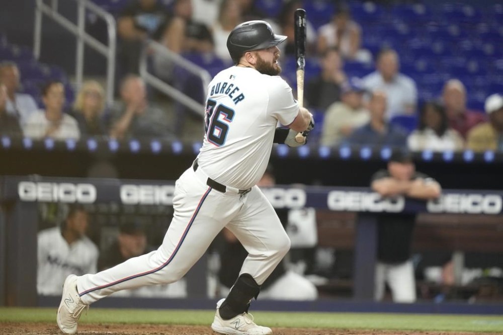 Miami Marlins' Jake Burger (36) follows through on a double during the third inning of a baseball game against the Arizona Diamondbacks, Tuesday, Aug. 20, 2024, in Miami. (AP Photo/Lynne Sladky)