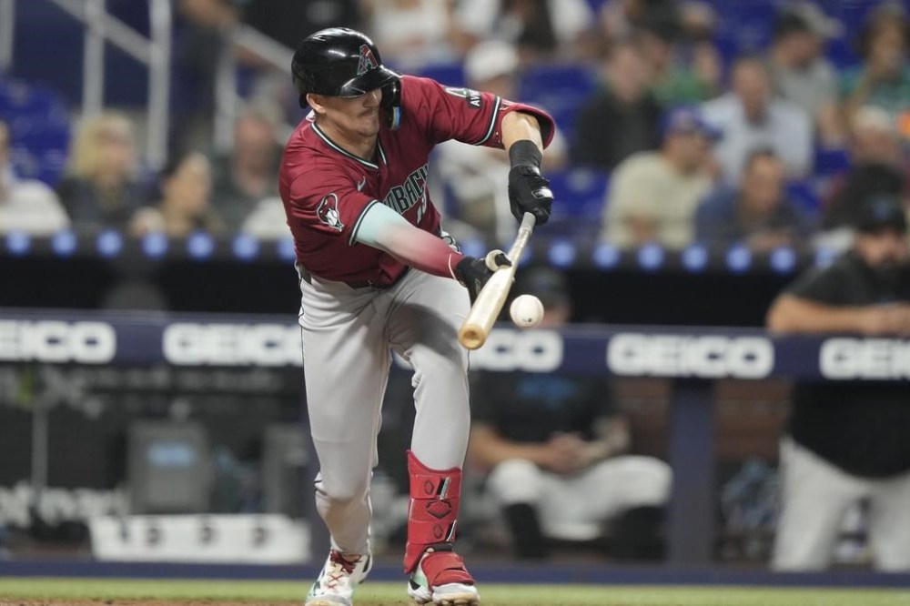 Arizona Diamondbacks' Kevin Newman attempts a bunt for a ground out during the fifth inning of a baseball game, against the Miami Marlins Tuesday, Aug. 20, 2024, in Miami. (AP Photo/Lynne Sladky)