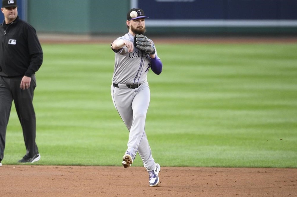Colorado Rockies second baseman Brendan Rodgers throws to first base to put out Washington Nationals' Juan Yepez during the second inning of a baseball game, Tuesday, Aug. 20, 2024, in Washington. (AP Photo/Nick Wass)