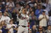 Detroit Tigers' Javier Báez raises his helmet to the fans on his first game back at Wrigley Field during the second inning to a baseball game against the Chicago Cubs Tuesday, Aug. 20, 2024, in Chicago. (AP Photo/Melissa Tamez)