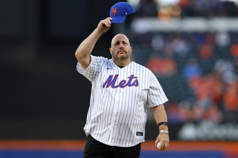 American actor and comedian Kevin James tips his cap before he throws out the ceremonial first pitch before a baseball game between the Baltimore Orioles and New York Mets, Tuesday, Aug. 20, 2024, in New York. (AP Photo/Rich Schultz)