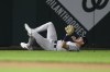 Colorado Rockies left fielder Nolan Jones slides on the grass after he caught a fly ball by Washington Nationals' Andres Chaparro for the out during the eighth inning of a baseball game, Tuesday, Aug. 20, 2024, in Washington. The Rockies won 3-1. (AP Photo/Nick Wass)