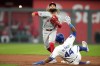 Los Angeles Angels second baseman Jack Lopez throws to first for the double play hit into by Kansas City Royals' Garrett Hampson after forcing Dairon Blanco (44) out at second during the third inning of a baseball game Tuesday, Aug. 20, 2024, in Kansas City, Mo. (AP Photo/Charlie Riedel)