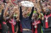 FILE - Leverkusen's head coach Xabi Alonso celebrates with the trophy as his team won the German Bundesliga, after the German Bundesliga soccer match between Bayer Leverkusen and FC Augsburg at the BayArena in Leverkusen, Germany, May 18, 2024. (AP Photo/Martin Meissner, File)