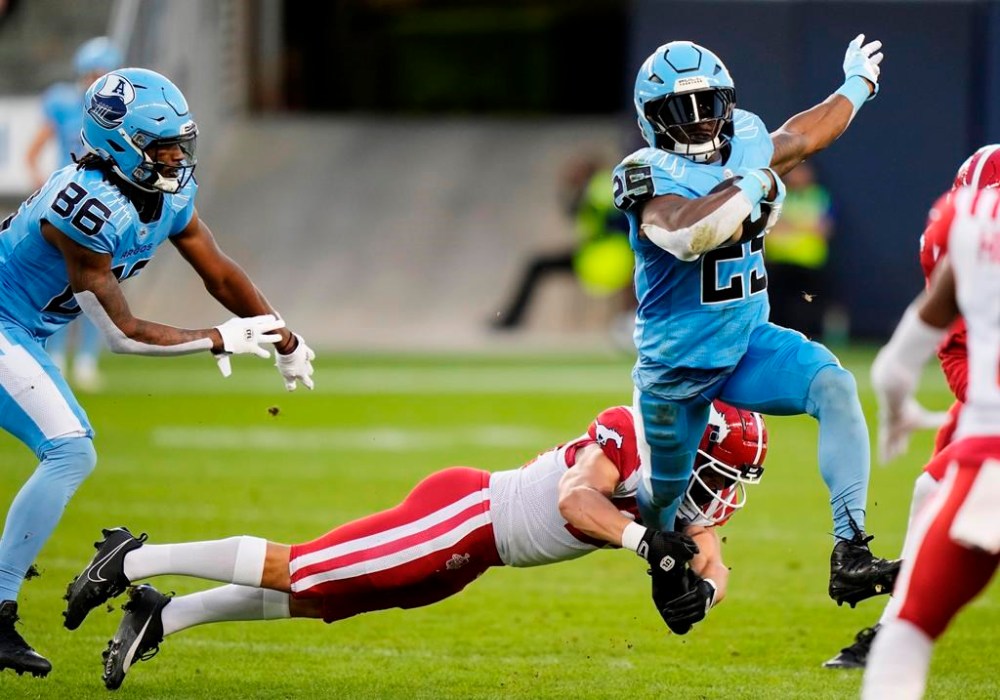 Ka'Deem Carey will become Chad Kelly's best friend when the Toronto Argonauts host the Saskatchewan Roughriders on Thursday. Carey (25) evades a tackle from Calgary Stampeders defensive back Bailey Devine-Scott (21) during first half CFL football action in Toronto on Friday, August 9, 2024. THE CANADIAN PRESS/Frank Gunn