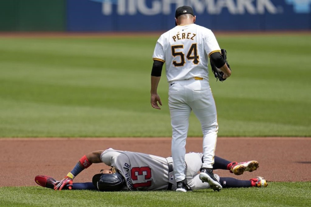 FILE - Pittsburgh Pirates starting pitcher Martín Pérez (54) checks on Atlanta Braves' Ronald Acuña Jr., who injured himself running the bases during the first inning of a baseball game against the Pittsburgh Pirates in Pittsburgh, Sunday, May 26, 2024. (AP Photo/Gene J. Puskar, File)
