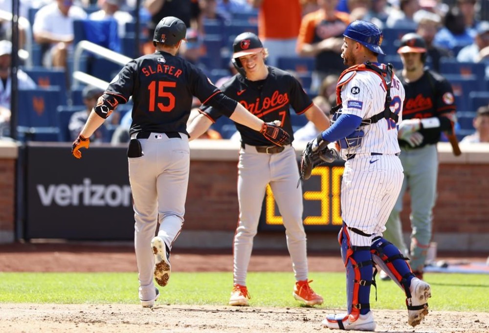 Baltimore Orioles' Austin Slater (15) celebrates with Jackson Holliday (7) after hitting a two run home run against the New York Mets during the sixth inning of a baseball game, Wednesday, Aug. 21, 2024, in New York. (AP Photo/Noah K. Murray)