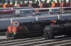 Employees are seen on a locomotive being moved at the Canadian Pacific Kansas City (CPKC) rail yard in Port Coquitlam, B.C., Monday, Aug. 19, 2024. THE CANADIAN PRESS/Darryl Dyck