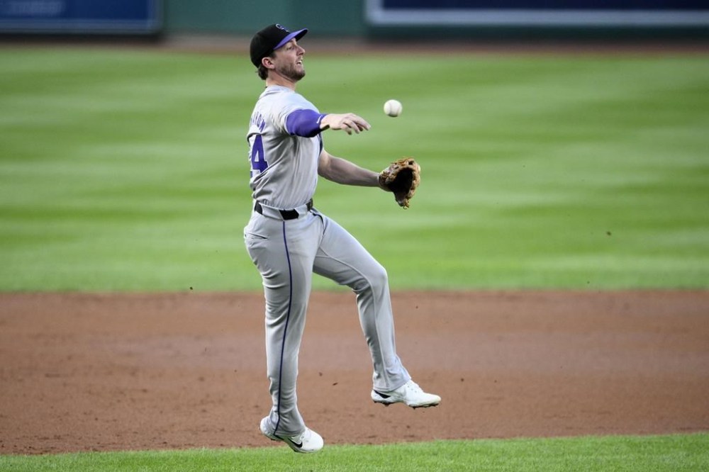 Colorado Rockies third baseman Ryan McMahon throws to first on a single by Washington Nationals' Jose Tena during the second inning of a baseball game, Wednesday, Aug. 21, 2024, in Washington. (AP Photo/Nick Wass)