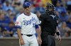 Kansas City Royals manager Matt Quatraro walks back to the dugout after talking to home plate umpire Mike Estabrook during the second inning of a baseball game against the Los Angeles Angels Wednesday, Aug. 21, 2024, in Kansas City, Mo. (AP Photo/Charlie Riedel)