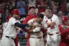St. Louis Cardinals' Nolan Arenado is congratulated by teammates including Willson Contreras, left, and Paul Goldschmidt (46) after hitting a walk-off grand slam to defeat the Milwaukee Brewers 10-6 in a baseball game Wednesday, Aug. 21, 2024, in St. Louis. (AP Photo/Jeff Roberson)