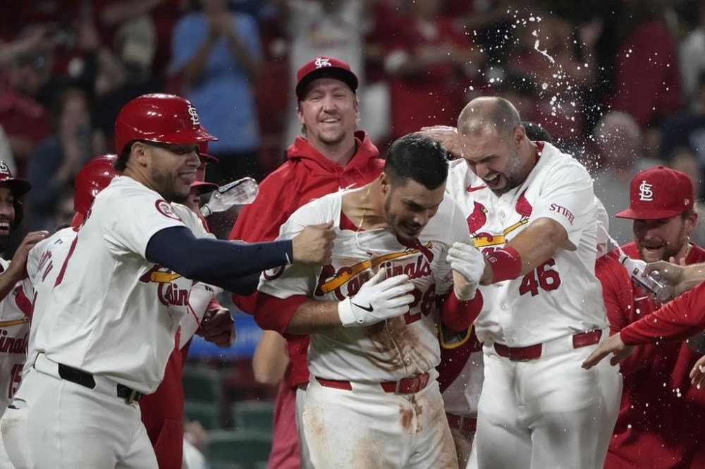 St. Louis Cardinals' Nolan Arenado is congratulated by teammates including Willson Contreras, left, and Paul Goldschmidt (46) after hitting a walk-off grand slam to defeat the Milwaukee Brewers 10-6 in a baseball game Wednesday, Aug. 21, 2024, in St. Louis. (AP Photo/Jeff Roberson)