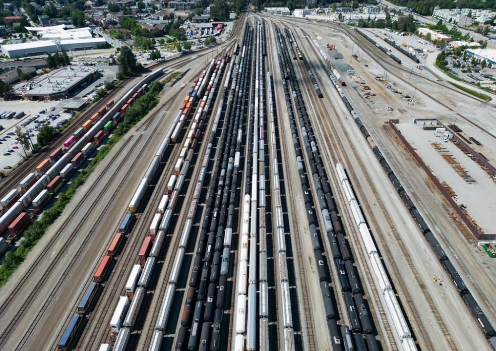 Rail and tanker cars and shipping containers sit idle at the Canadian Pacific Kansas City (CPKC) rail yard in Port Coquitlam, B.C., Monday, Aug. 19, 2024. THE CANADIAN PRESS/Darryl Dyck