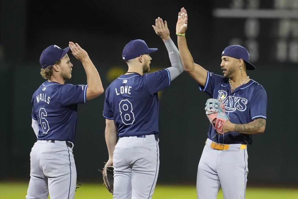 Tampa Bay Rays' Taylor Walls (6) celebrates with Brandon Lowe (8) and Jose Siri after the Rays defeated the Oakland Athletics in a baseball game in Oakland, Calif., Wednesday, Aug. 21, 2024. (AP Photo/Jeff Chiu)