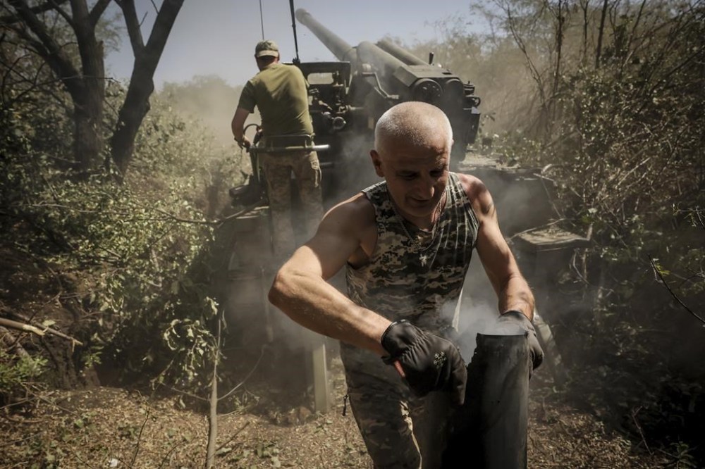 In this photo provided by Ukraine's 24th Mechanised Brigade press service, servicemen of the 24th Mechanised Brigade fire a