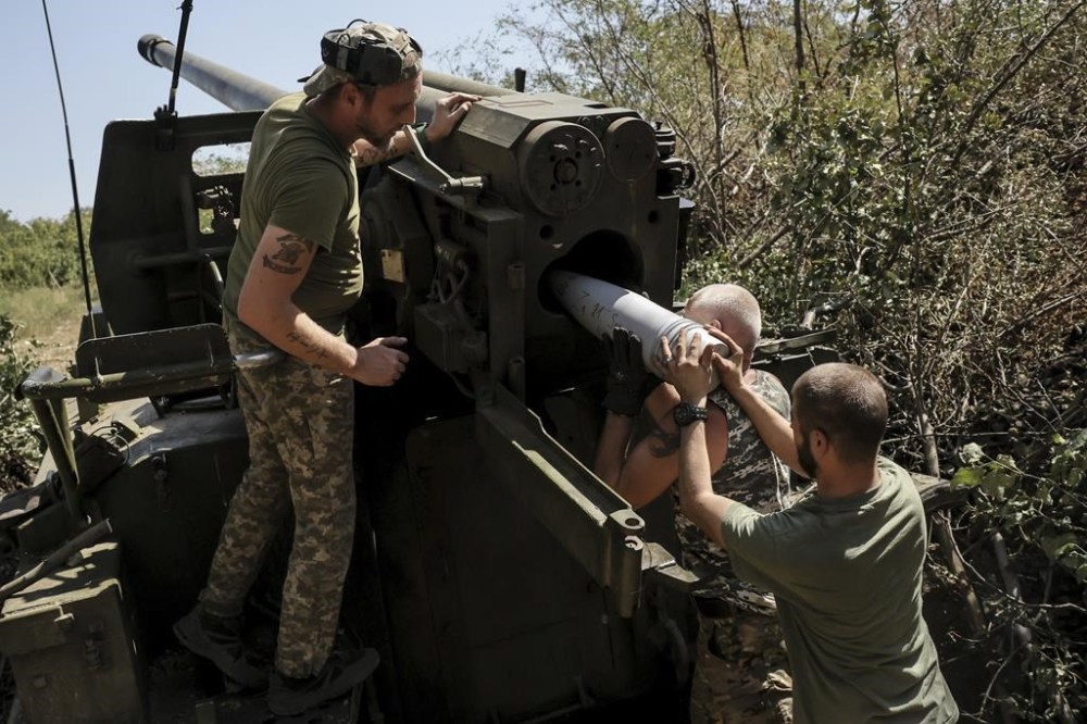 In this photo provided by Ukraine's 24th Mechanised Brigade press service, servicemen of the 24th Mechanised Brigade fire a