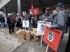 Rail workers picket in front of CN headquarters on the first day of a nationwide rail shutdown, after workers were locked out by CN and CPKC when new contract agreements weren't reached by the midnight deadline, in Montreal, Thursday, Aug. 22, 2024. Economists say the work stoppage will have a significant effect on the country's economy. THE CANADIAN PRESS/Ryan Remiorz