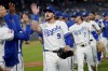 Kansas City Royals' Vinnie Pasquantino (9) celebrates with teammates after their baseball game against the Los Angeles Angels Wednesday, Aug. 21, 2024, in Kansas City, Mo. The Royals won 3-0. (AP Photo/Charlie Riedel)