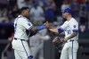 Kansas City Royals catcher Salvador Perez and relief pitcher Lucas Erceg (60) celebrate after their baseball game against the Los Angeles Angels Wednesday, Aug. 21, 2024, in Kansas City, Mo. The Royals won 3-0. (AP Photo/Charlie Riedel)