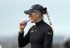 England's Charley Hull vapes on her way to the 3rd tee during the first round of the Women's British Open golf championship, in St Andrews, Scotland Thursday, Aug. 22, 2024. (AP Photo/Scott Heppell)