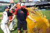 Washington Nationals starting pitcher Patrick Corbin, center, gets doused by Luis Garcia Jr., left, and Ildemaro Vargas, right, after a baseball game against the Colorado Rockies, Thursday, Aug. 22, 2024, in Washington. Corbin got his 100th win. The Nationals won 8-3. (AP Photo/Nick Wass)