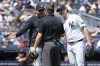 New York Yankees manager Aaron Boone, left, and pitcher Gerrit Cole, right, talk to an umpire, center, during the second inning of a baseball game against the Cleveland Guardians, Thursday, Aug. 22, 2024, in New York. (AP Photo/Pamela Smith)