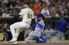 New York Mets' Jesse Winker, right, slides into home plate, scoring from third off a passed ball as San Diego Padres starting pitcher Dylan Cease awaits the throw during the fourth inning of a baseball game Thursday, Aug. 22, 2024, in San Diego. (AP Photo/Gregory Bull)
